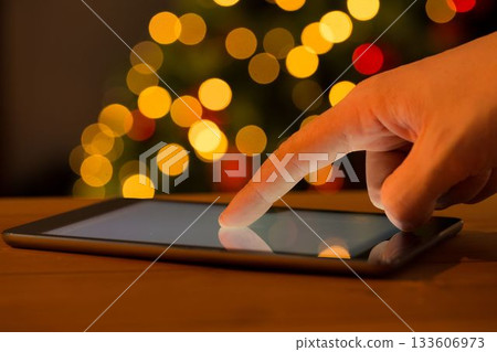 Close-up of person using digital tablet during Christmas Close-up of person using digital tablet during Christmas 133606973