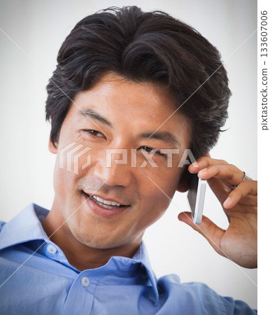 Smiling asian man on the phone 133607006
