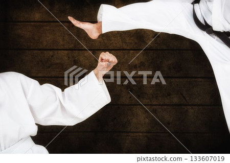 Fighters posing against wooden planks Fighters posing against wooden planks 133607019