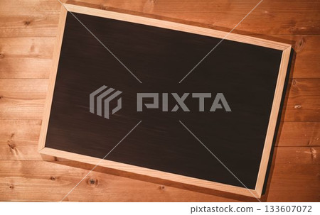 Small blackboard on wooden floor 133607072