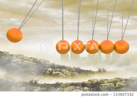 Newtons cradle above city in mountains Newtons cradle above city in mountains 133607192