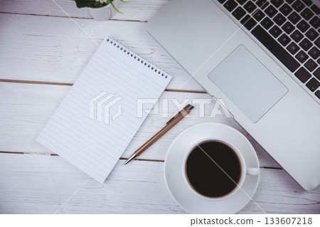 Directly above view of laptop with book and coffee cup 133607218