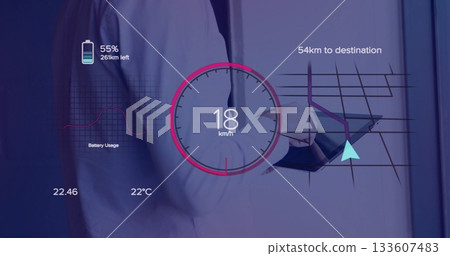 Executive reviewing data on tablet in office corridor, with speedometer, map and battery overlays Executive reviewing data on tablet in office corridor, with speedometer, map and battery overlays 133607483
