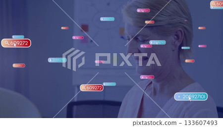 Analyzing senior woman reviewing data labels in office room, with whiteboard sketches, copy space 133607493