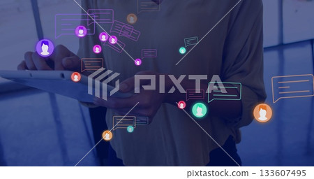 Woman in professional attire scanning digital icons on tablet in office lobby, digital theme Woman in professional attire scanning digital icons on tablet in office lobby, digital theme 133607495