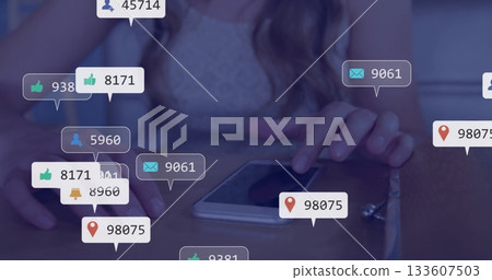 Showing woman's hands in lace top tapping smartphone on table, with social media notifications 133607503