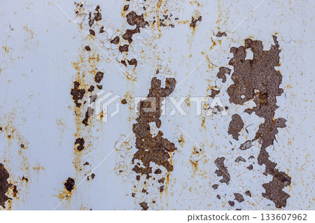 Abstract texture of cracked surface with rusty orange cracks on light background.Texture of metal sheet. 133607962