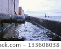 Discharge of dirty industrial wastewater into sea on waterfront. 133608038