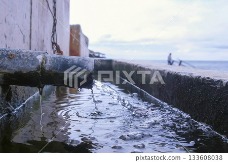 Discharge of dirty industrial wastewater into sea on waterfront. Discharge of dirty industrial wastewater into sea on waterfront. 133608038