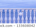 White fence with balloon on sea waterfront in a cloudy day. Beautiful seascape. 133608042