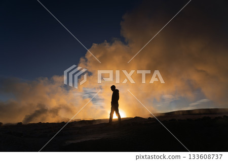 Hiker silhouette walking through geothermal steam, Sol de Manana, Bolivia 133608737