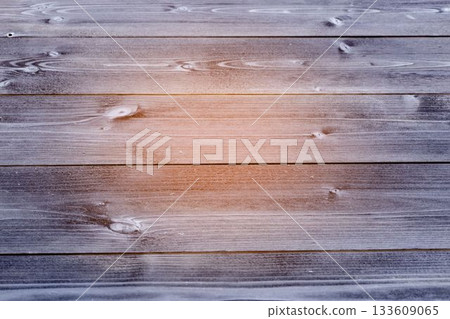 Weathered wooden planks are showcasing grain and knots in flat design, with warm light highlight Weathered wooden planks are showcasing grain and knots in flat design, with warm light highlight 133609065