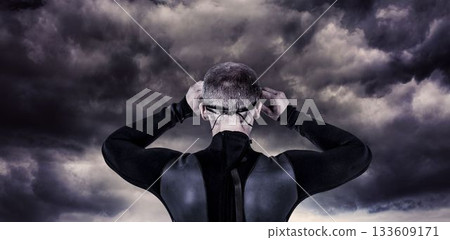 Rear view of male swimmer against cloudy sky Rear view of male swimmer against cloudy sky 133609171