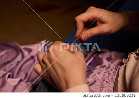 Crochet workshop scene, Artisan at work with yarn, Cozy crafting space with textured handmade stitches, Quiet studio environment dedicated to knitting and crochet crafts today Crochet workshop scene, Artisan at work with yarn, Cozy crafting space with textured handmade stitches, Quiet studio environment dedicated to knitting and crochet crafts today 133609231