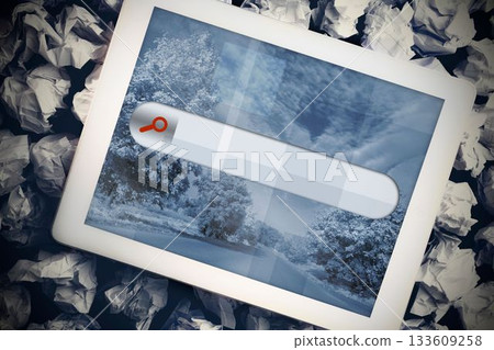 Tablet with search bar on crumpled up paper 133609258