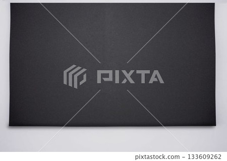 Flat design is featuring large black board lying across clean white studio backdrop 133609262