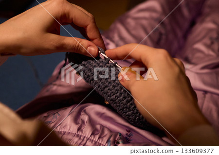 Crochet workshop scene, Artisan at work with yarn, Cozy crafting space with textured handmade stitches, Quiet studio environment dedicated to knitting and crochet crafts today 133609377