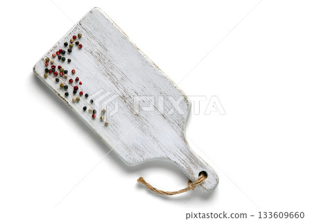 White wooden board with sprinkled multi-colored peppercorns isolated on white background. White wooden board with sprinkled multi-colored peppercorns isolated on white background. 133609660