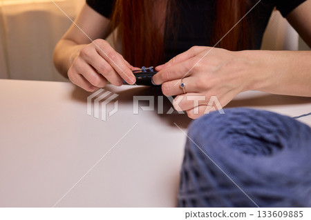 Crochet workshop scene, Artisan at work with yarn, Cozy crafting space with textured handmade stitches, Quiet studio environment dedicated to knitting and crochet crafts today Crochet workshop scene, Artisan at work with yarn, Cozy crafting space with textured handmade stitches, Quiet studio environment dedicated to knitting and crochet crafts today 133609885