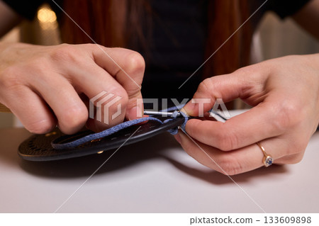 Crochet workshop scene, Artisan at work with yarn, Cozy crafting space with textured handmade stitches, Quiet studio environment dedicated to knitting and crochet crafts today Crochet workshop scene, Artisan at work with yarn, Cozy crafting space with textured handmade stitches, Quiet studio environment dedicated to knitting and crochet crafts today 133609898
