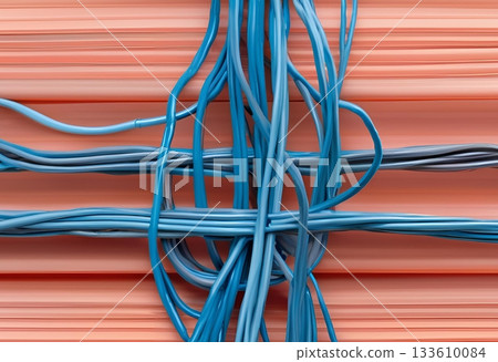 Tangled blue electrical wires against a peach background. AI Generated 133610084