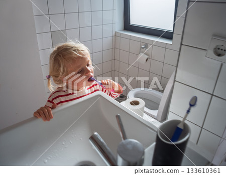 Little 4 yea old girl learning to brush her teeth by herself Little 4 yea old girl learning to brush her teeth by herself 133610361