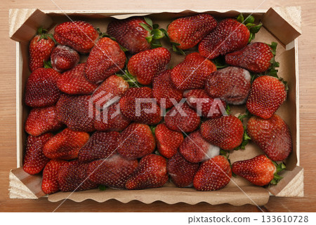 Moldy strawberries in a rustic wooden fruit crate Moldy strawberries in a rustic wooden fruit crate 133610728