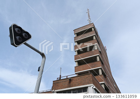 a striking upward perspective of a red brick high-rise building with minimalist modernist architecture 133611059