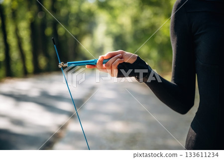 Close up view of woman with jump rope outdoors Close up view of woman with jump rope outdoors 133611234