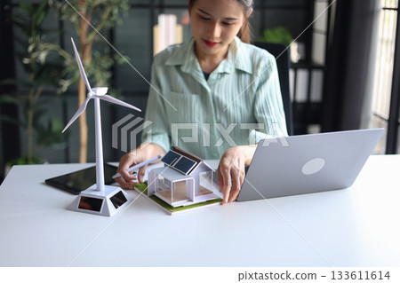 Beautiful engineer working in office design eco friendly and sustainable living home. Beautiful engineer working in office design eco friendly and sustainable living home. 133611614