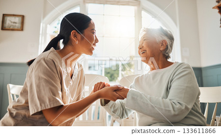 A warm moment of care as care staff smile and connect with an elderly woman A warm moment of care as care staff smile and connect with an elderly woman 133611866