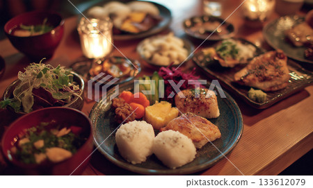 Enjoy a colorful Japanese lunch plate and healthy meal in a cafe surrounded by the warmth of wood and natural light. Enjoy a colorful Japanese lunch plate and healthy meal in a cafe surrounded by the warmth of wood and natural light. 133612079