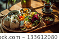 Enjoy a colorful Japanese lunch plate and healthy meal in a cafe surrounded by the warmth of wood and natural light. Enjoy a colorful Japanese lunch plate and healthy meal in a cafe surrounded by the warmth of wood and natural light. 133612080