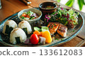 Enjoy a colorful Japanese lunch plate and healthy meal in a cafe surrounded by the warmth of wood and natural light. Enjoy a colorful Japanese lunch plate and healthy meal in a cafe surrounded by the warmth of wood and natural light. 133612083