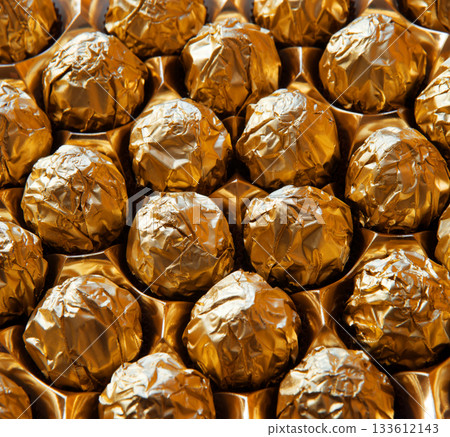 Golden candies in a big box Golden candies in a big box 133612143