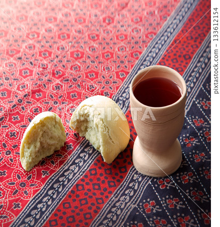 Wine in a gobled and bread 133612154