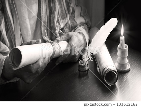 Man holding an old scroll 133612162