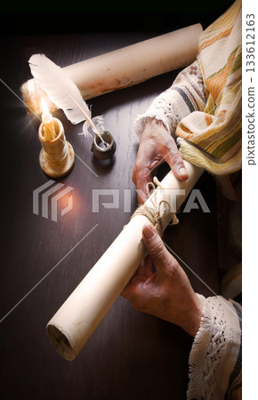 Man holding an old scroll 133612163