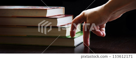 Hand walking on a ladder made of books Hand walking on a ladder made of books 133612171