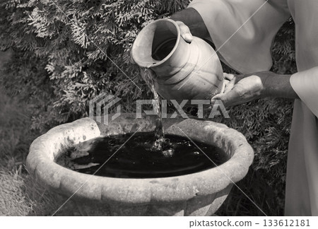 Hands pour water into the pot 133612181