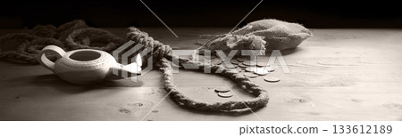 Coins on the table with rope for the gallows 133612189