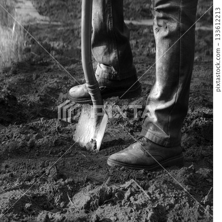 Man's feet with a shovel 133612213