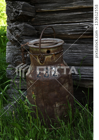 an old rusty milk can with the number 232 painted on it an old rusty milk can with the number 232 painted on it 133612558