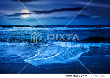 black sea waves crashing sandy beach at night. summer vacation on a windy weather under dark cloudy sky in full moon light. view of dramatic seascape. background for investment or abstract concepts black sea waves crashing sandy beach at night. summer vacation on a windy weather under dark cloudy sky in full moon light. view of dramatic seascape. background for investment or abstract concepts 133613022