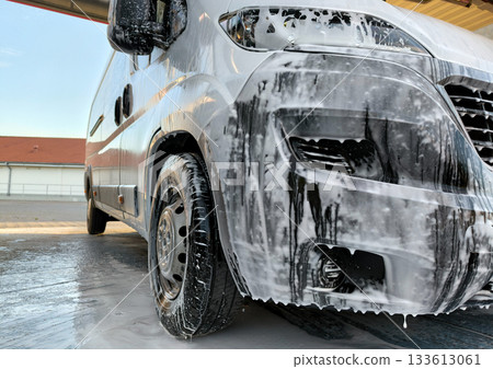 Self-service car wash. Washing the machine using active foam Self-service car wash. Washing the machine using active foam 133613061