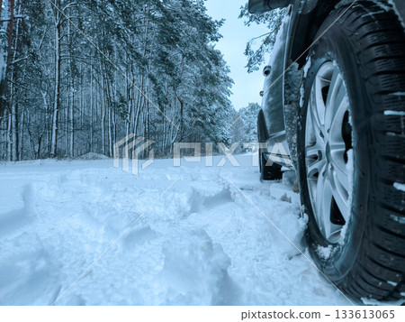 Car tires in the snow close-up. Winter tires as the basis of travel safety in the winter season. Car tires in the snow close-up. Winter tires as the basis of travel safety in the winter season. 133613065