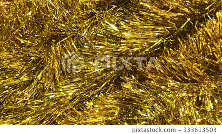 Golden tinsel Christmas tree bokeh background. Festive pattern. Xmas holiday spirit. 133613503