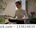 Daily Kitchen Routine at Home. Real Life Moments of a Young Woman 133614630