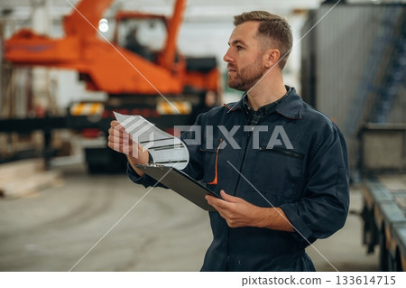 Male worker is in the modern warehouse or manufacturing company 133614715