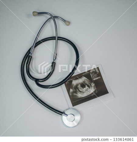 Stethoscope is there. Picture of ultrasonic test is on the white table, conception of healthcare Stethoscope is there. Picture of ultrasonic test is on the white table, conception of healthcare 133614861